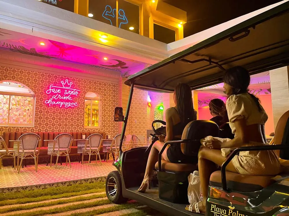 Guests pulling up in a golf cart to the Plaza Playa Palmera at Playa Palmera Beach Resort